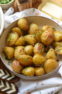 Garlic butter roasted potatoes in a bowl.