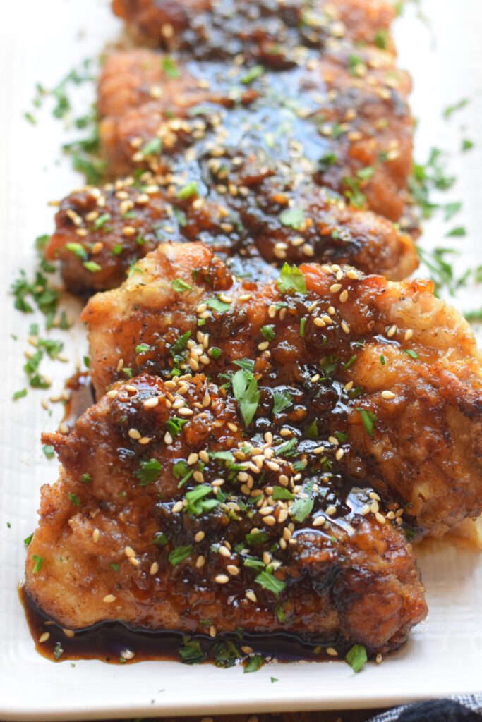 Close up of soy ginger chicken on a plate.