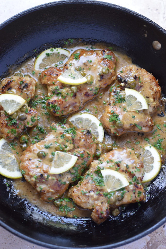 Lemon caper chicken in a skillet.