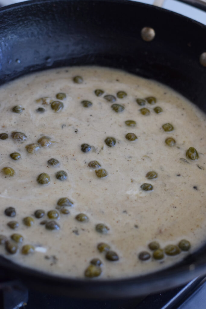 Caper lemon sauce in a large frying pan.