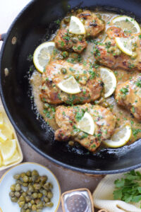 Lemon caper chicken in a skillet.