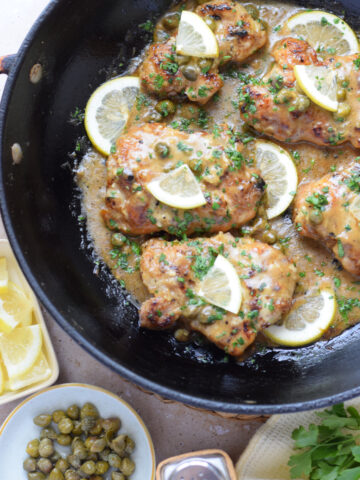 Lemon caper chicken in a skillet.