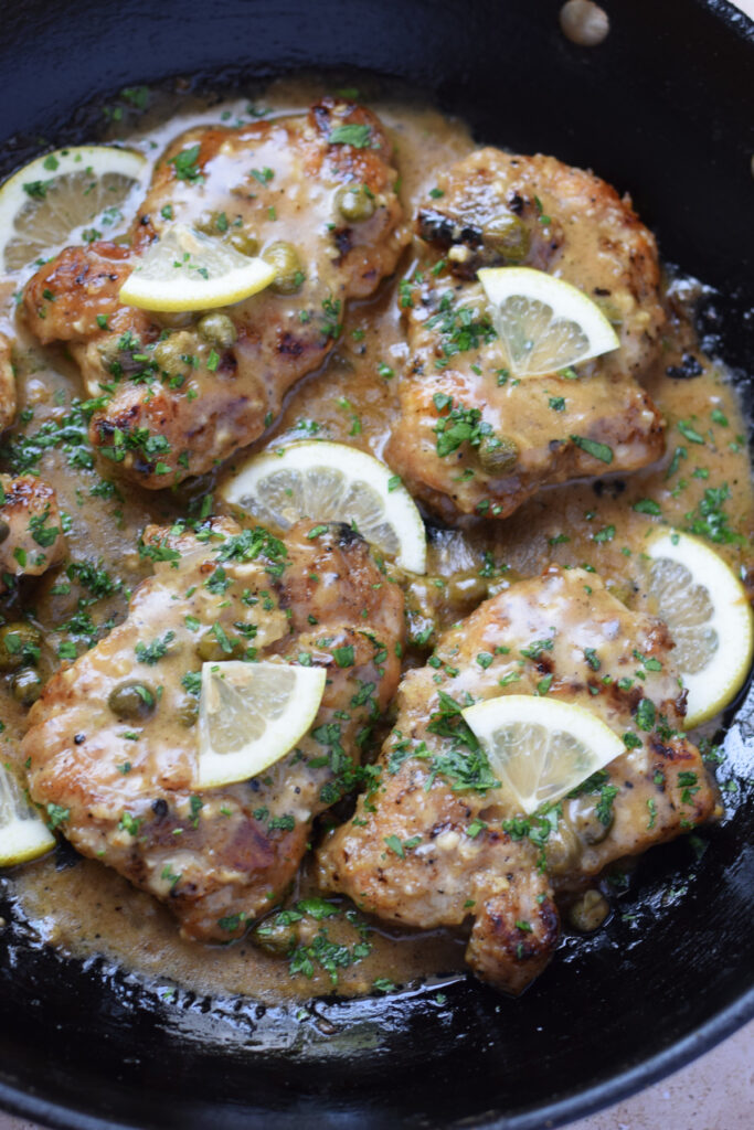 Lemon caper chicken in a skillet.