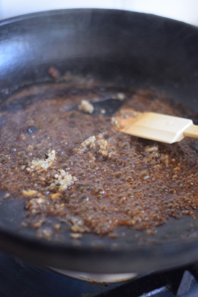 Making a soy garlic sauce in a skillet.