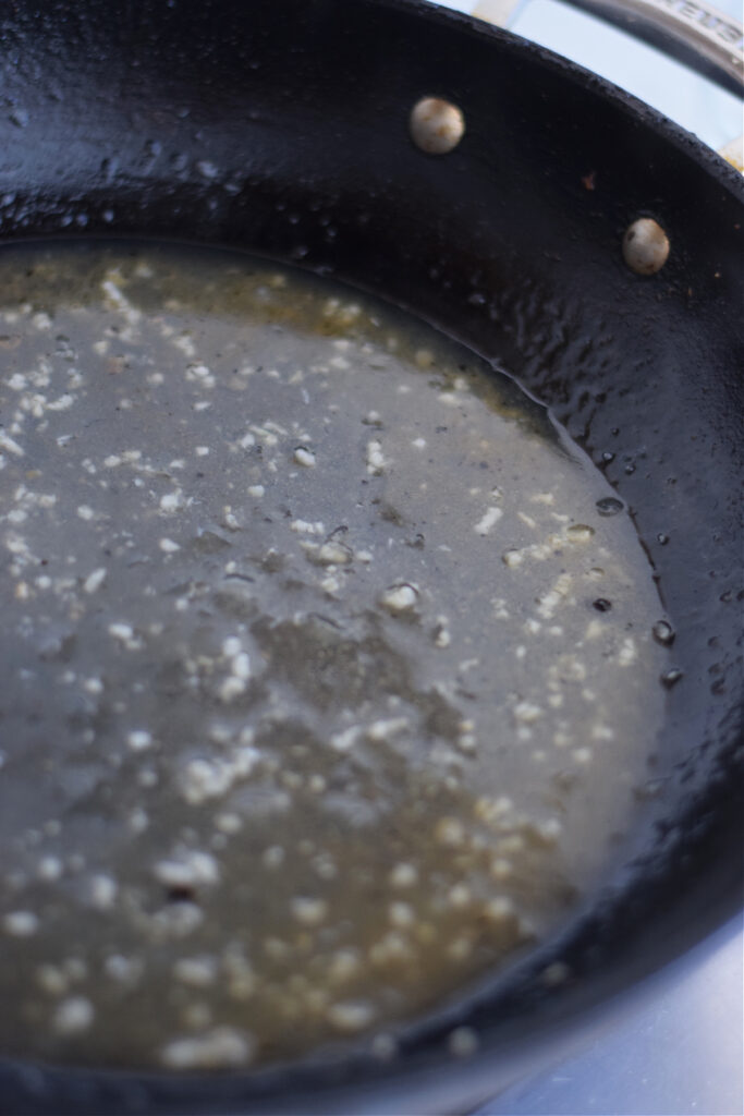 Making a lemon caper sauce in a skillet.