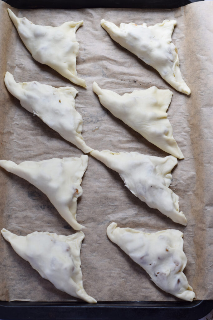 Making pear turnovers on a baking tray.