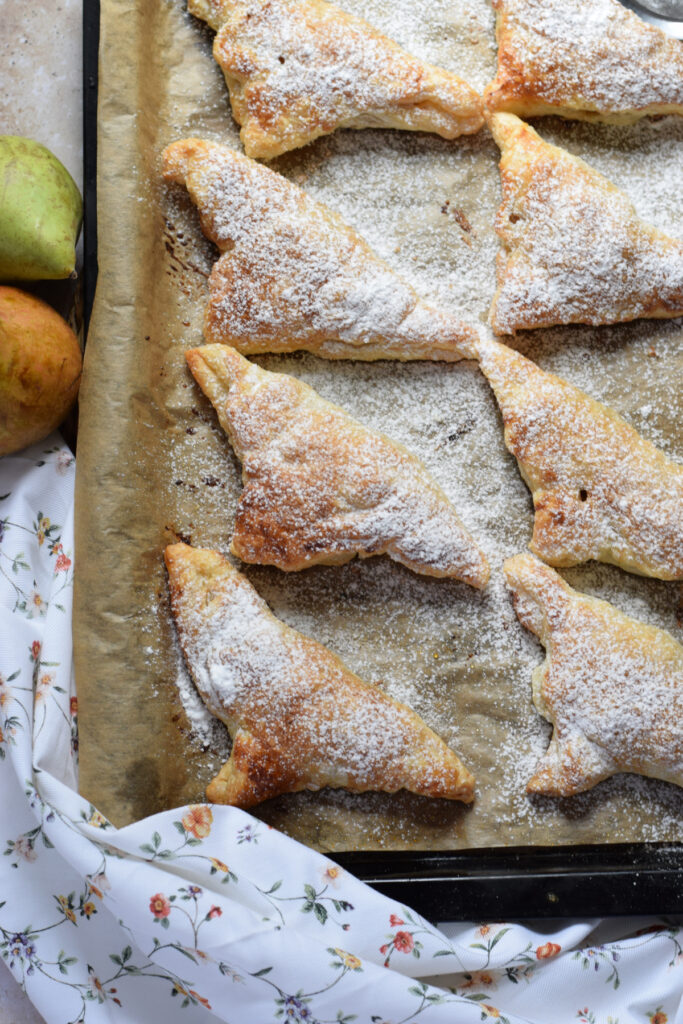 Pear turnovers on a tray.