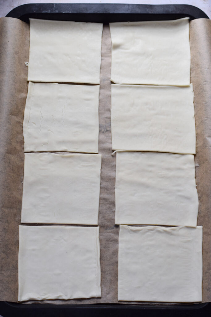 Pastry squares on a baking tray.