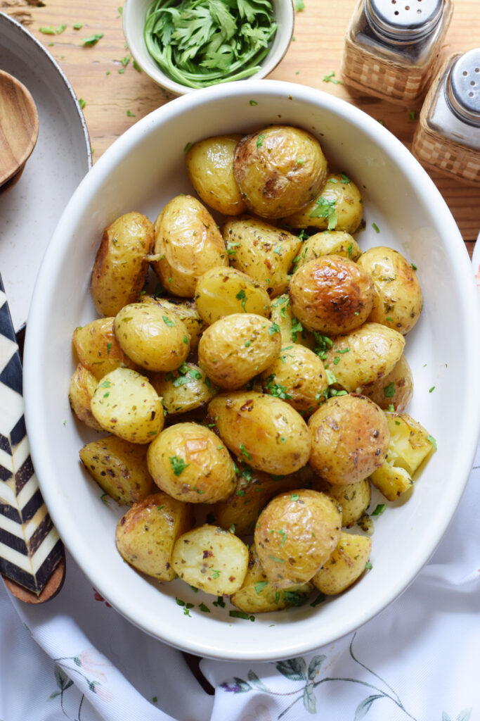 Garlic potatoes in a white serving dish.