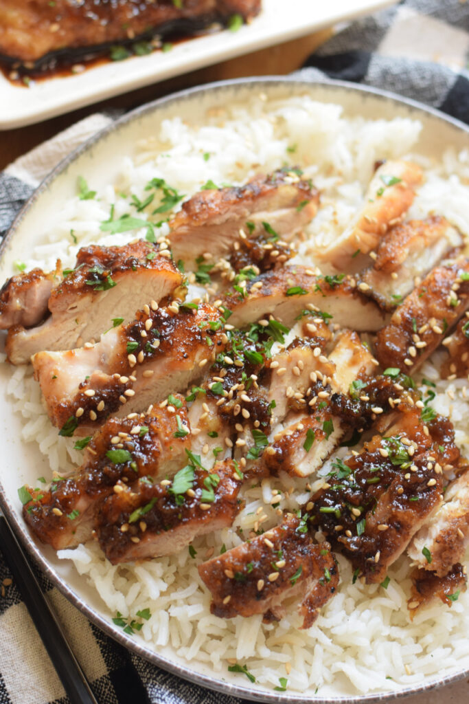 Slices of ginger chicken on rice.