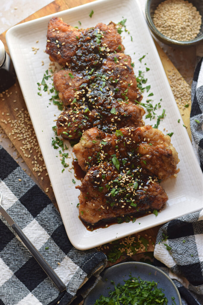 Soy ginger chicken on a white plate.