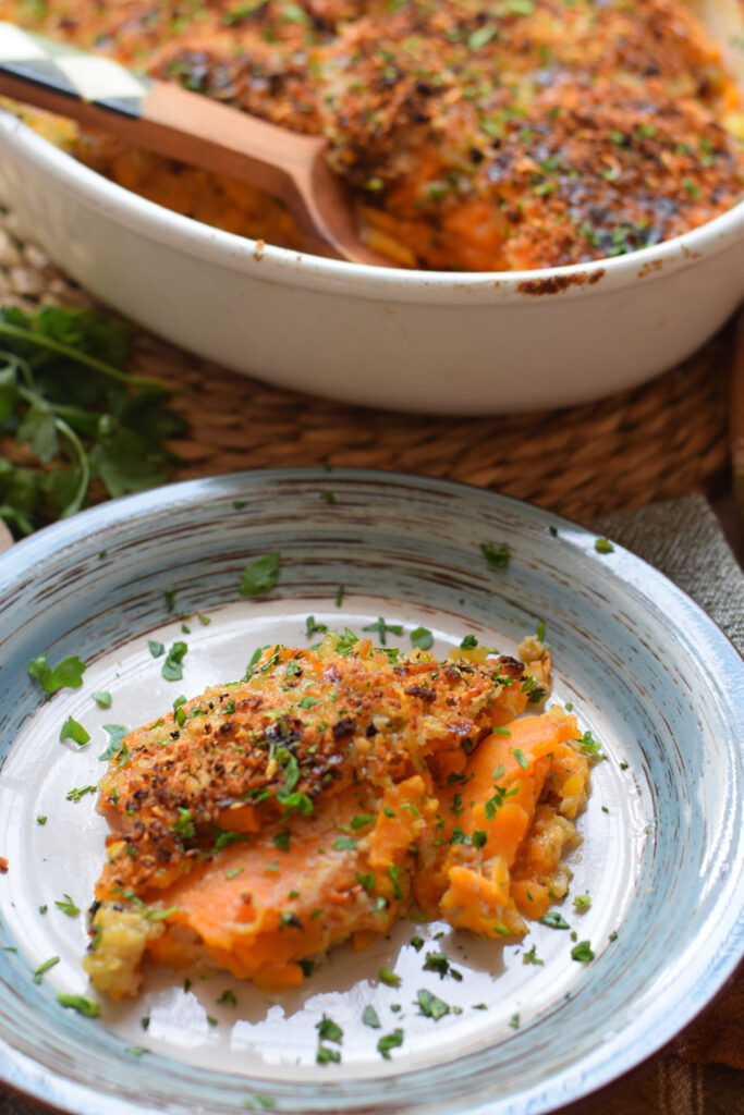 Sweet potato gratin on a white dinner plate.