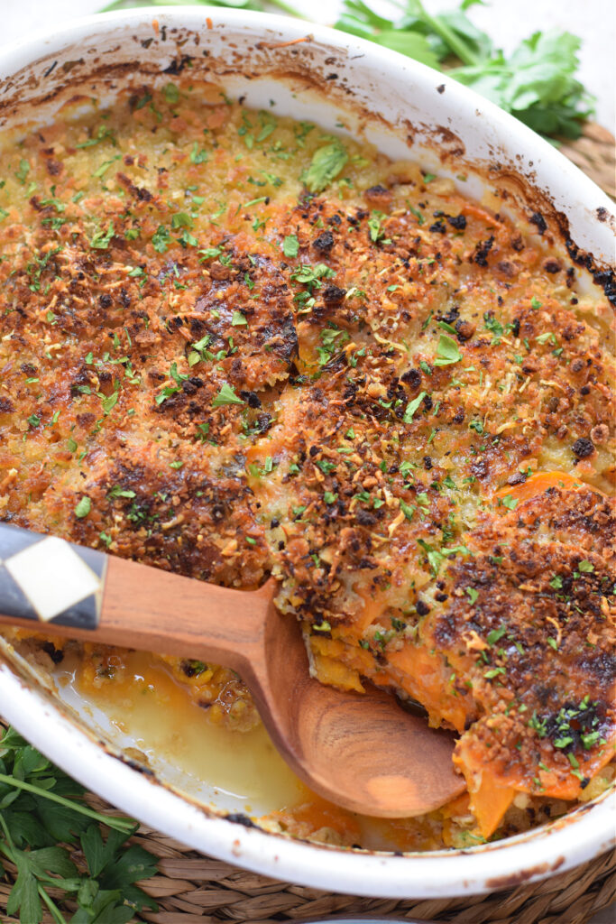 Sweet potato gratin in a white serving dish.