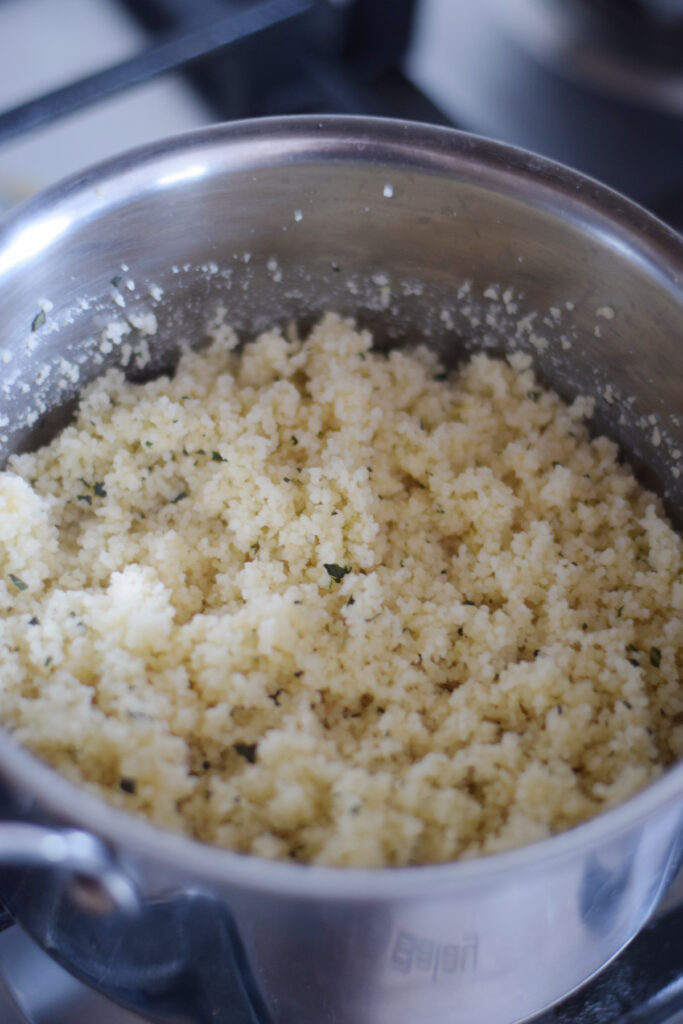 Seasoned couscous in a saucepan.