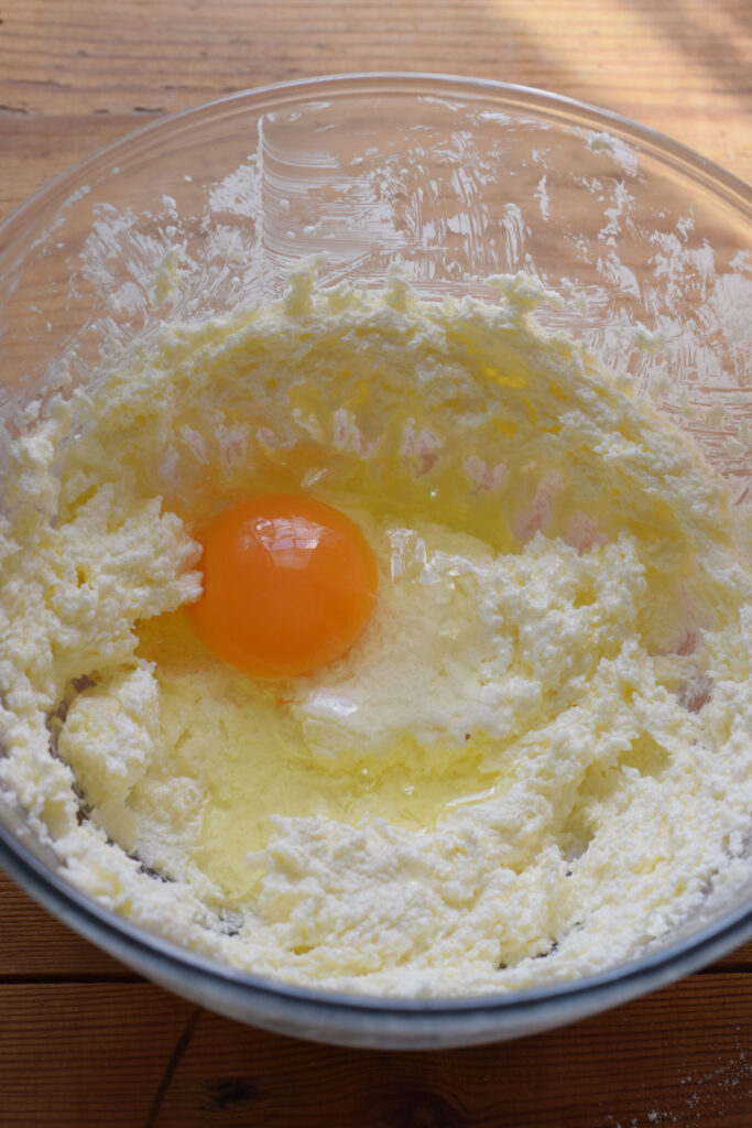 Adding eggs to muffin batter.