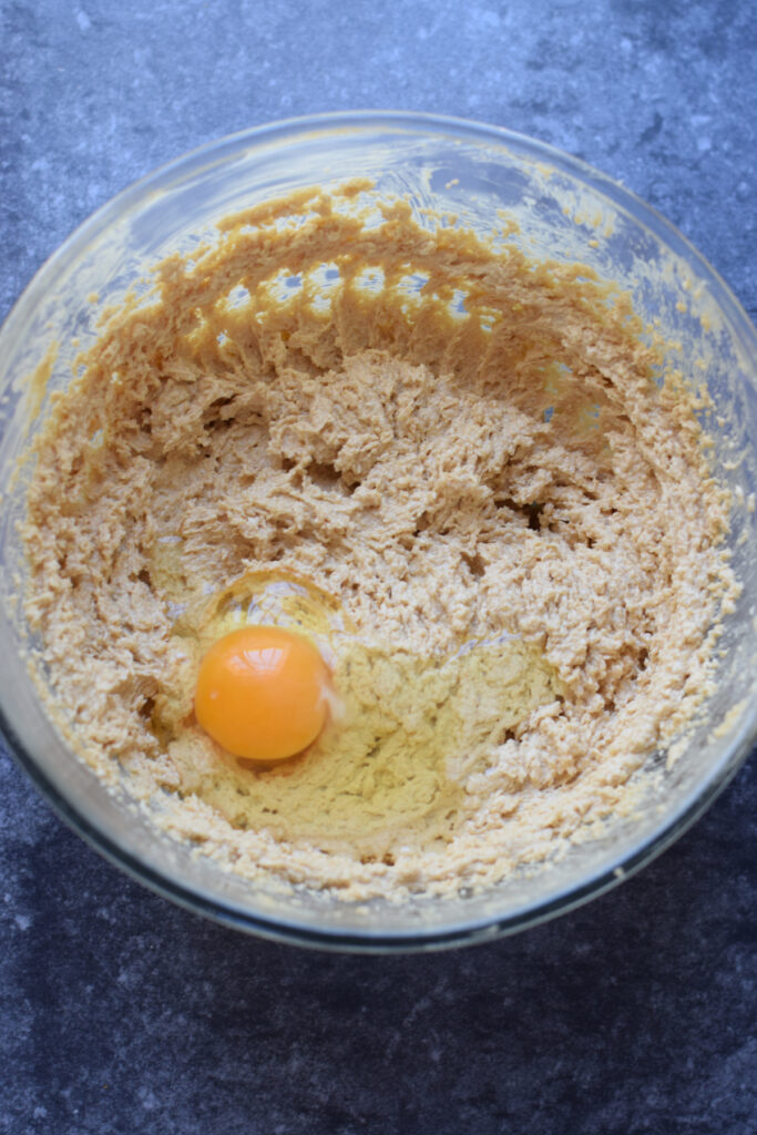 Mixing in eggs to cookie batter.