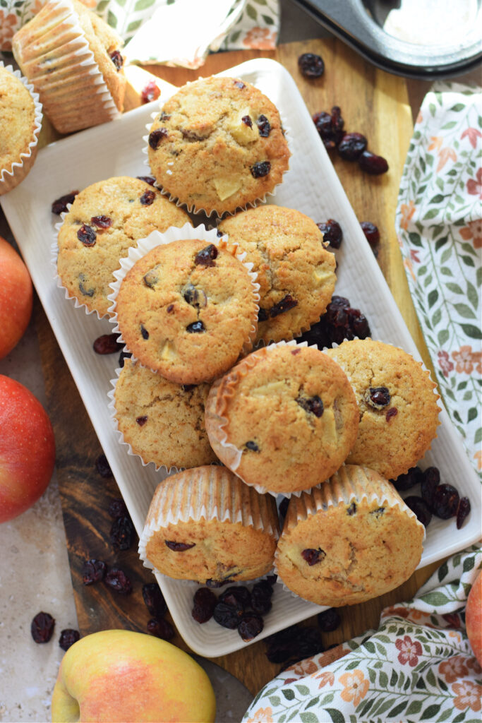 Apple cranberry muffins on a white plate.