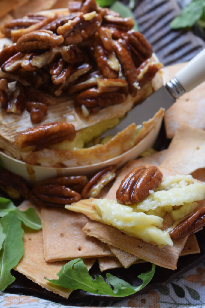 Baked brie with pecans and maple syrup.