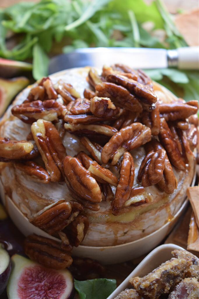 This Maple Pecan Baked Brie is the appetizer that you'll want to save in favourites for this holiday season.  Creamy baked brie topped with toasted pecans tossed maple syrup.  Serve it with crackers or crisp pieces of baguette bread.