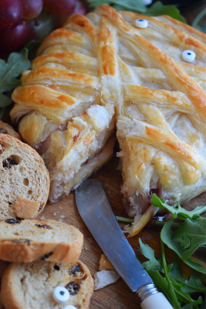 Close up of baked brie with jam and pastry.