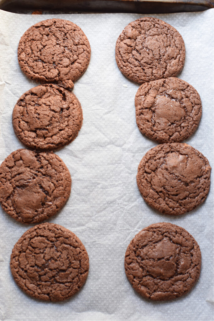 Baked chocolate cookies on a tray.