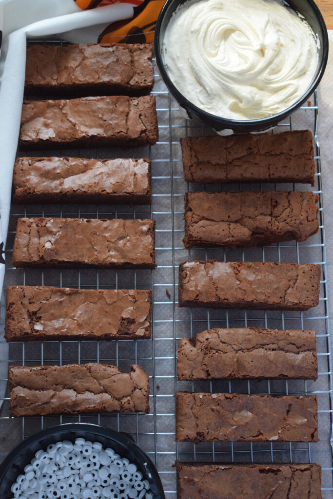 Brownie slices on a cooling rack with icing.