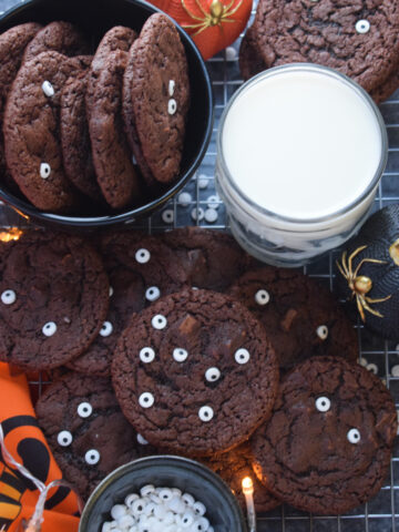 Halloween cookies with decorations and a glass of milk.