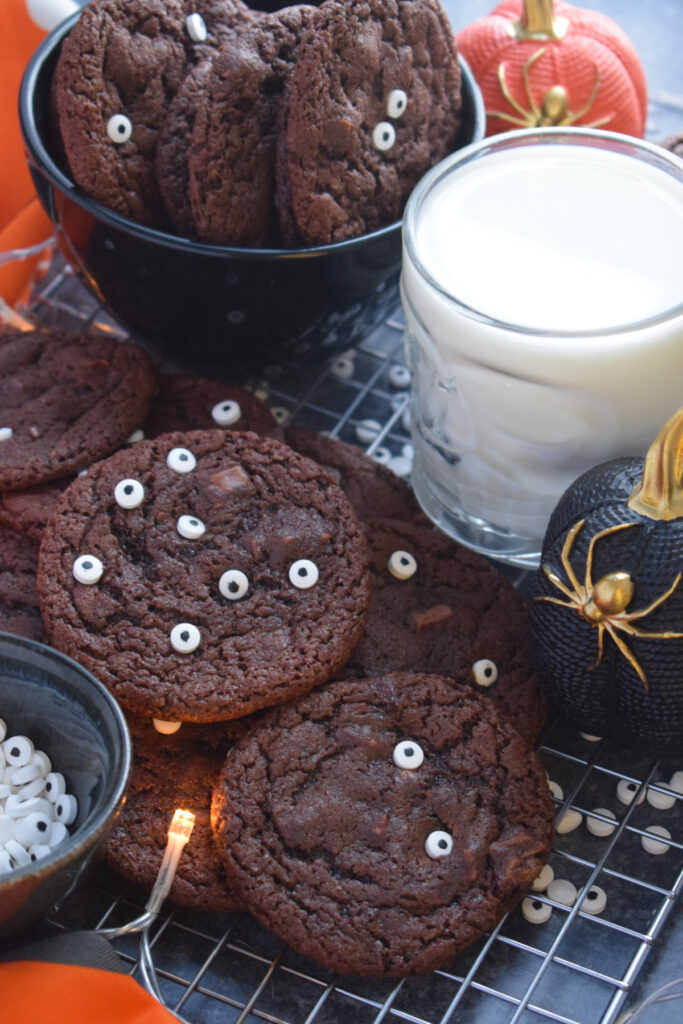 Double chocolate halloween cookies with a glass of milk.