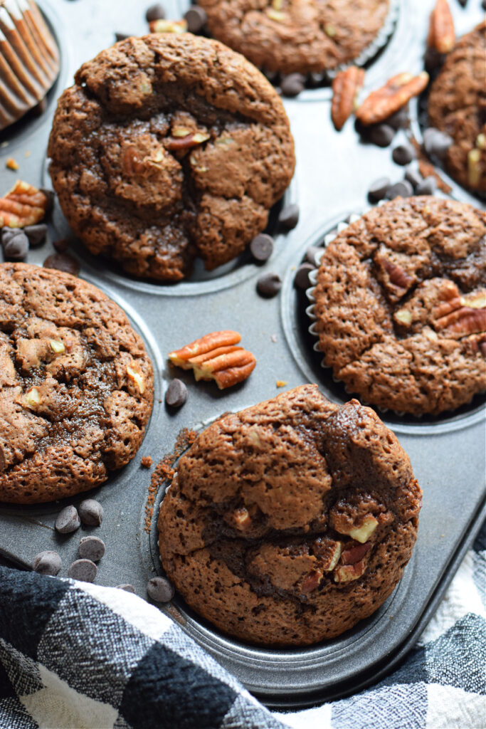 Close up of chocolate chip muffins with pecans.