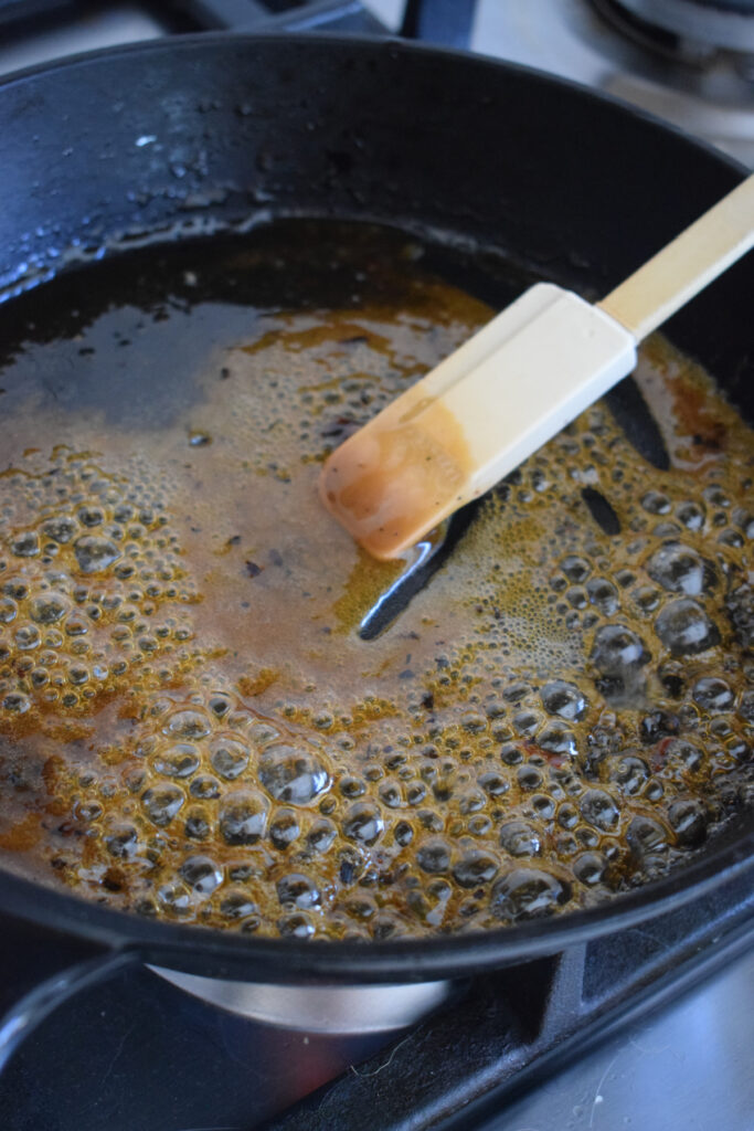 Cooking maple syrup in a skillet.