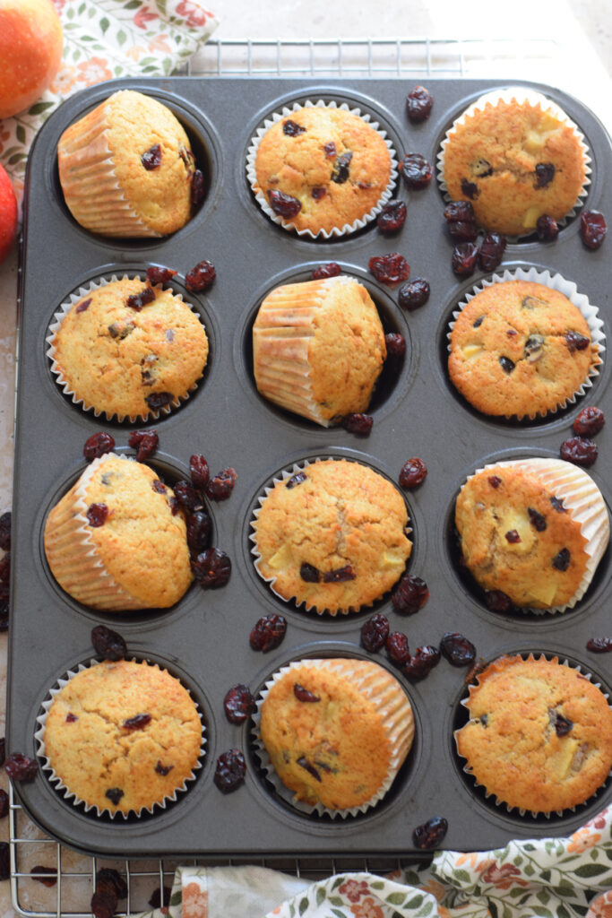 Apple cranberry muffins in a muffin tray.