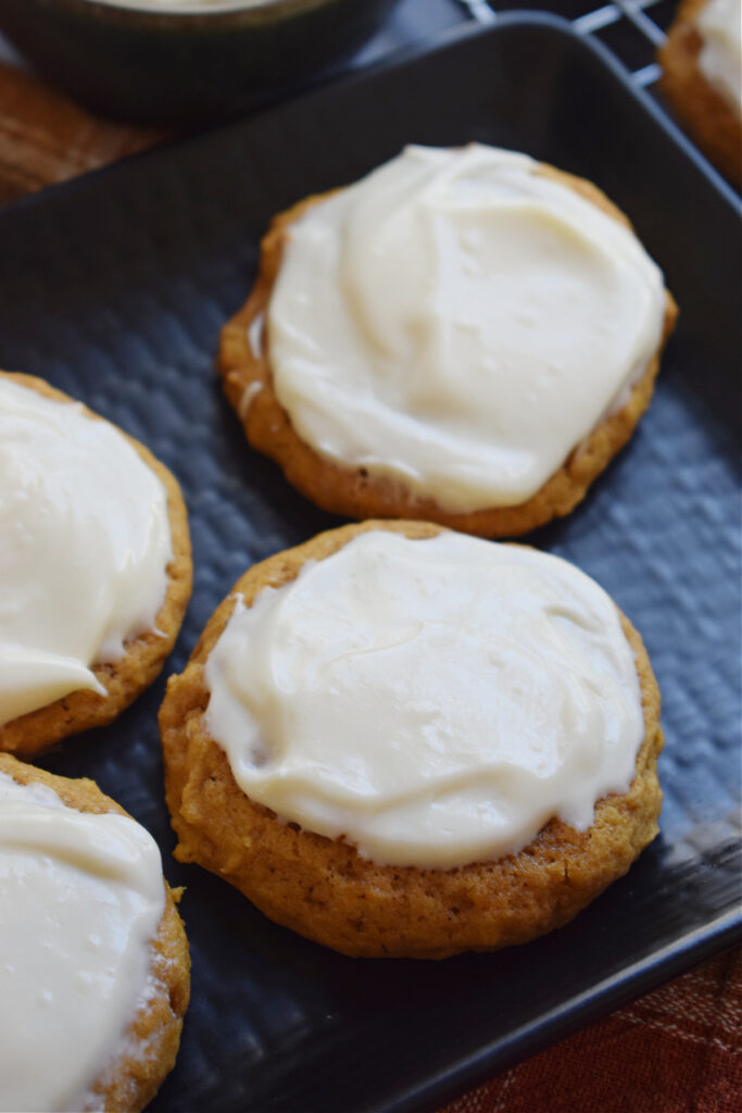 Close up of frosted pumpkin cookies.