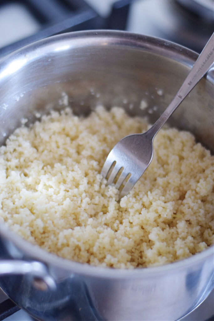 Fluffed couscous in a saucepan.