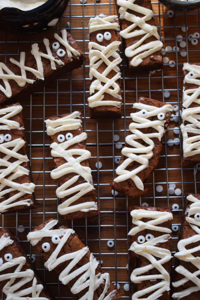 Mummy brownies on a cooling rack.