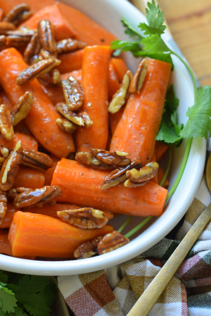 Close up of roasted carrots with maple and pecans.