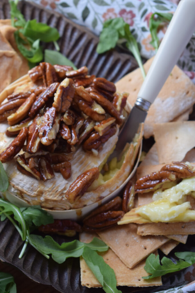 Maple pecan topped brie cheese appetizer.