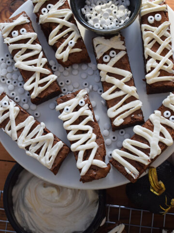 Halloween mummy brownies on a white plate.