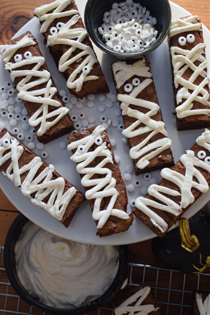 Halloween mummy brownies on a white plate.