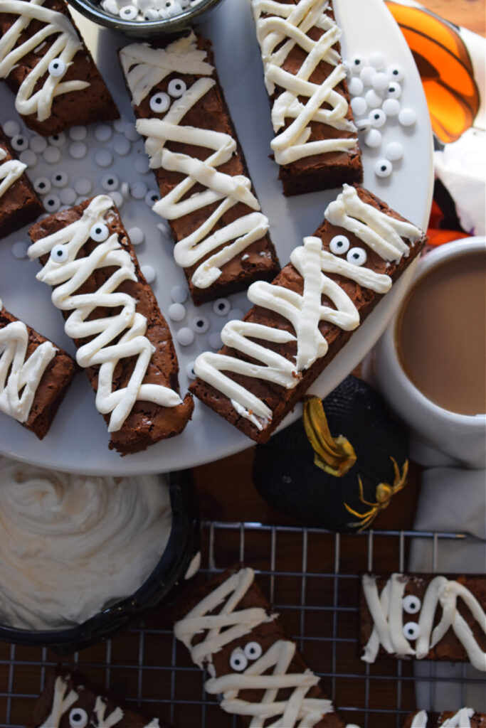 Chocolate mummy brownies on a white plate.