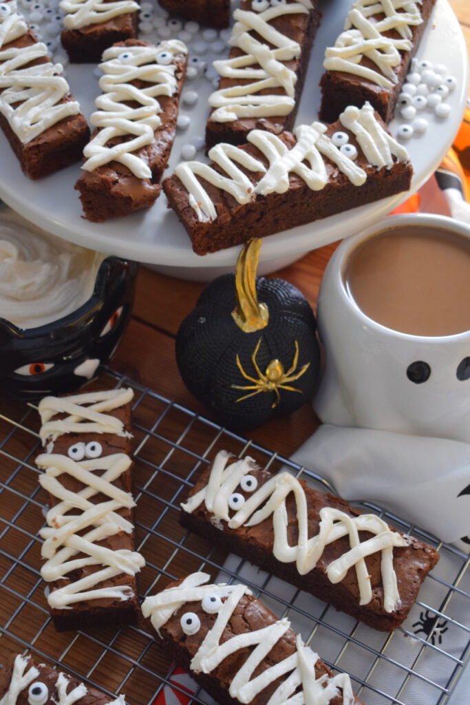 Chocolate mummy brownies on a white plate.