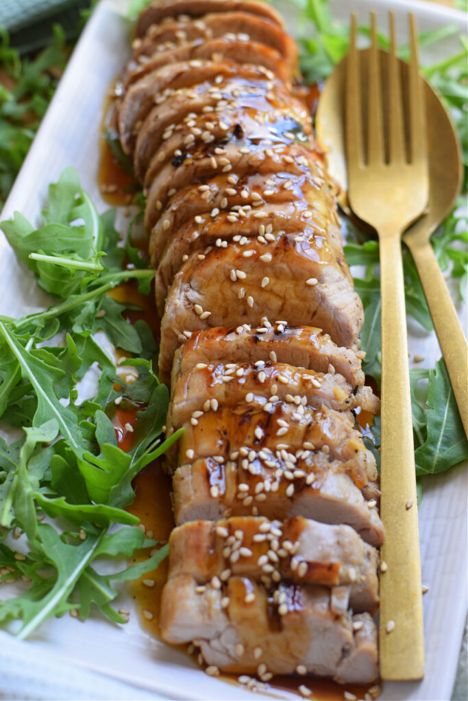 Pork tenderloin with sauce on a white plate