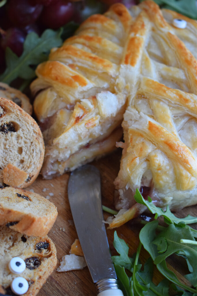 Close up of baked brie with crackers.