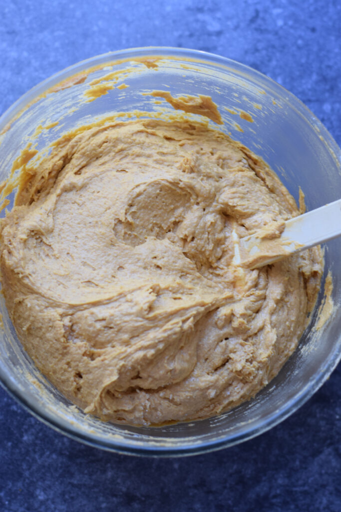 Pumpkin cookie dough in a glass bowl.