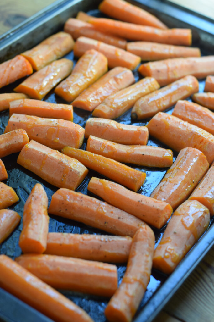 Roasted carrots on a baking tray.