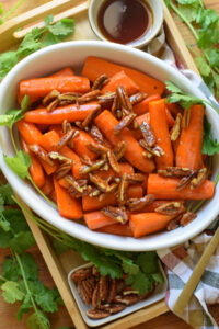 Carrots in a white dish.