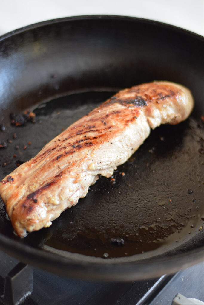 Searing pork in a large skillet