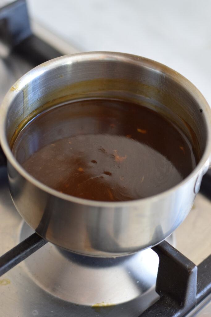 Making a soy based sauce in a saucepan.