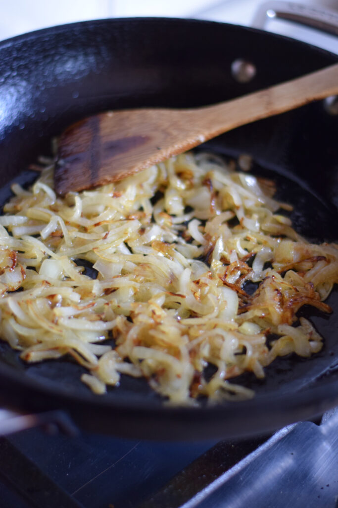 Cooking onions in a skillet.