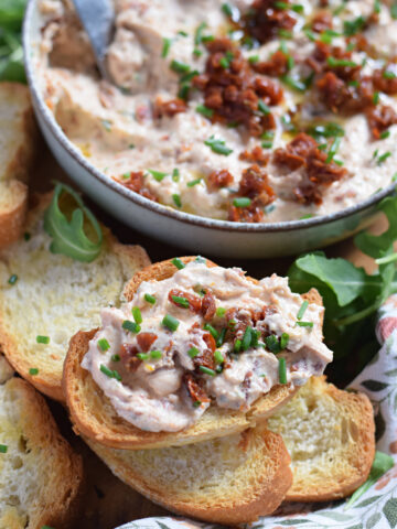 Sun dried tomato dip on a baguette slice.