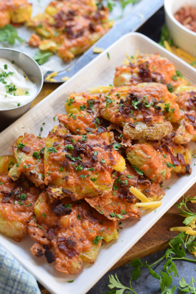 Bacon cheese potatoes on a white plate.